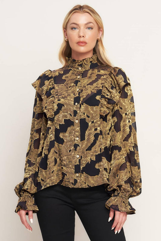 a woman in a black and gold shirt