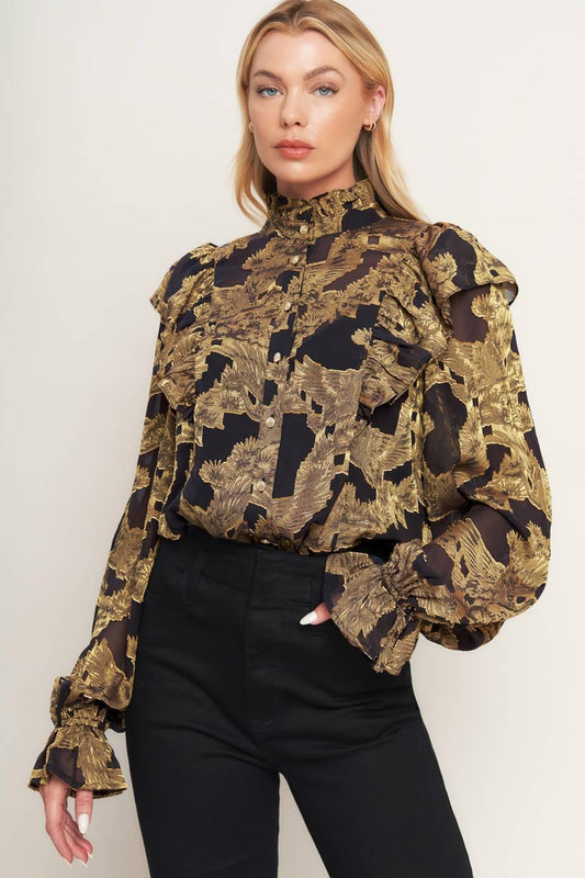 a woman in a black and gold blouse