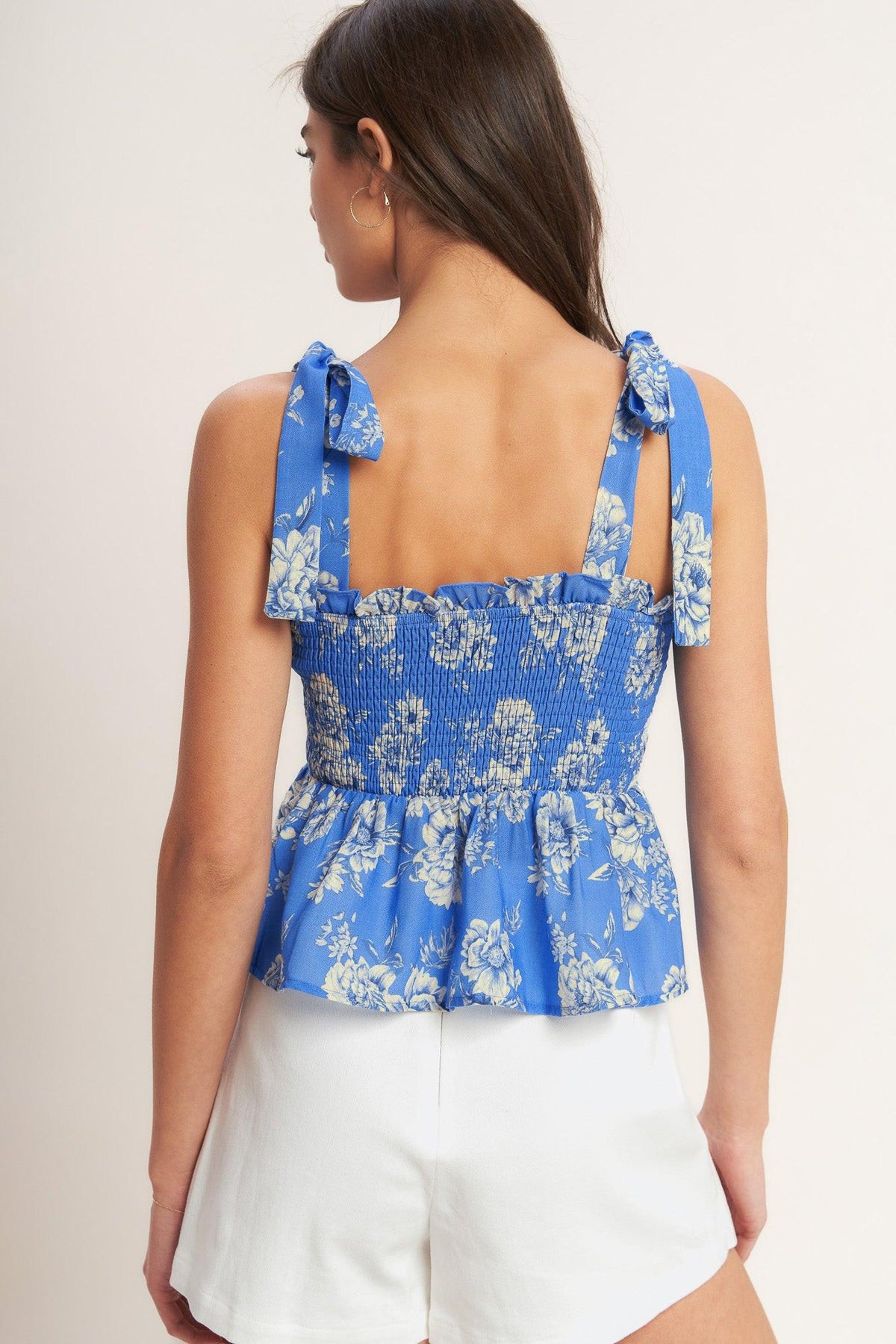 a woman wearing a blue and white top