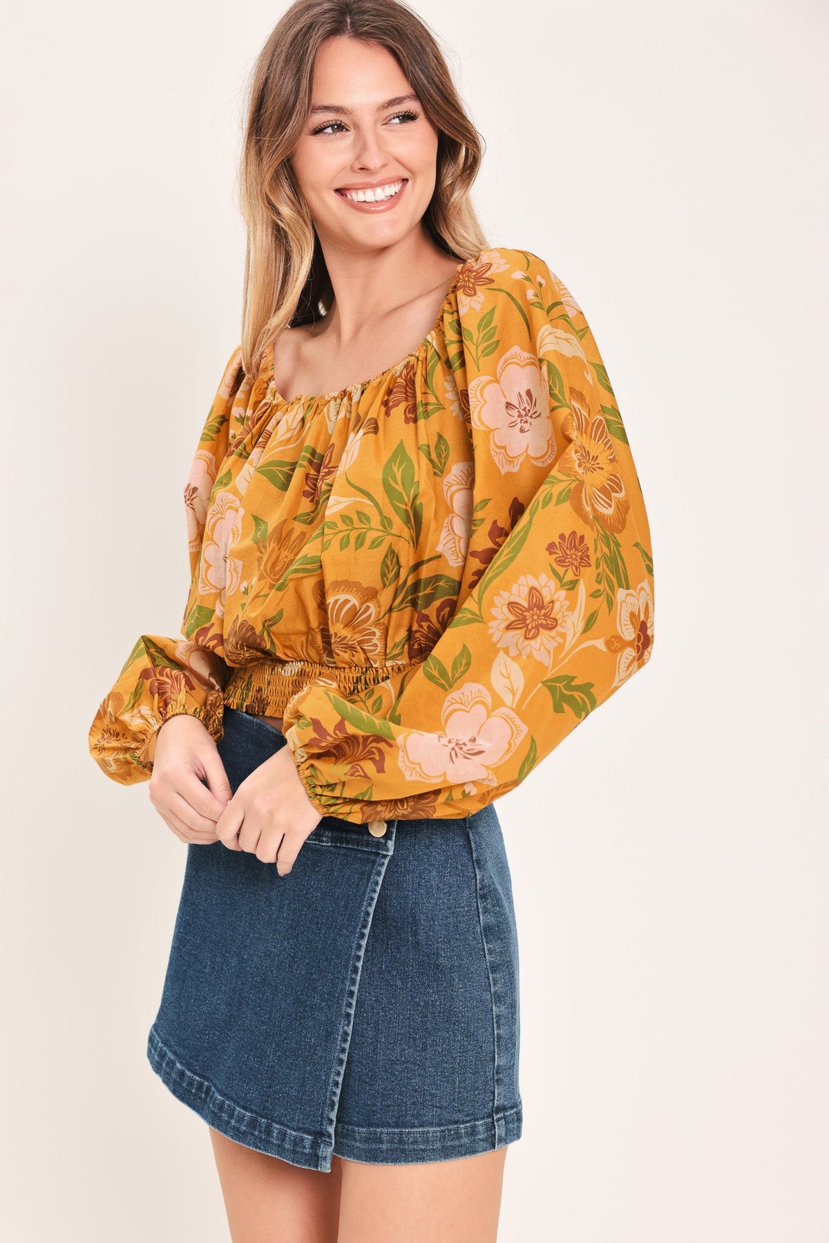 a woman in a yellow floral shirt