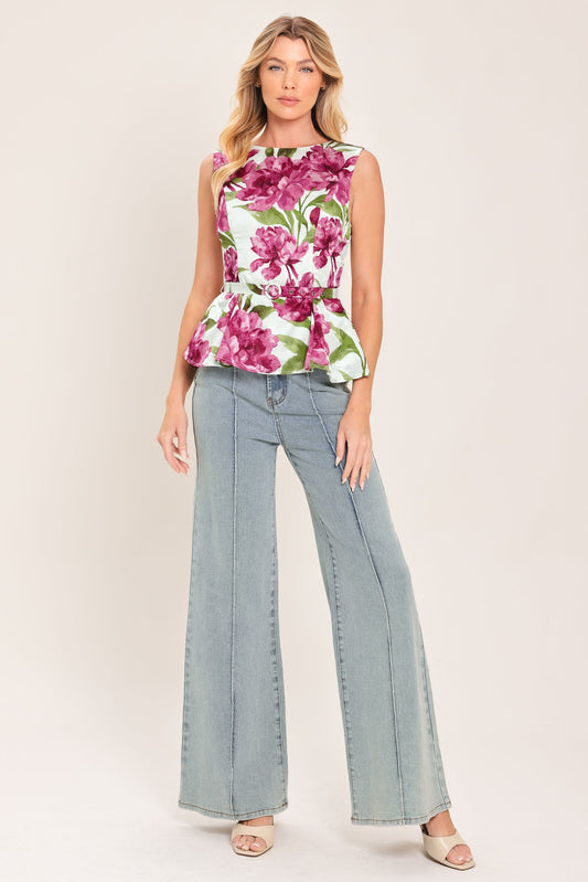 a woman in a floral top and jeans