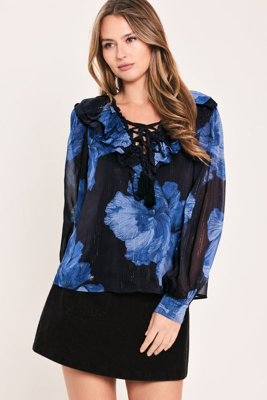 a woman in a blue and black blouse