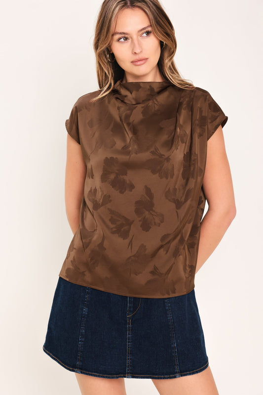 a woman in a brown shirt