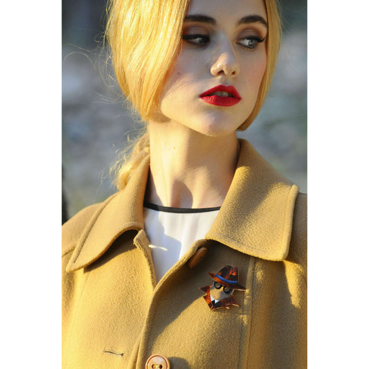 a woman with blonde hair wearing a coat