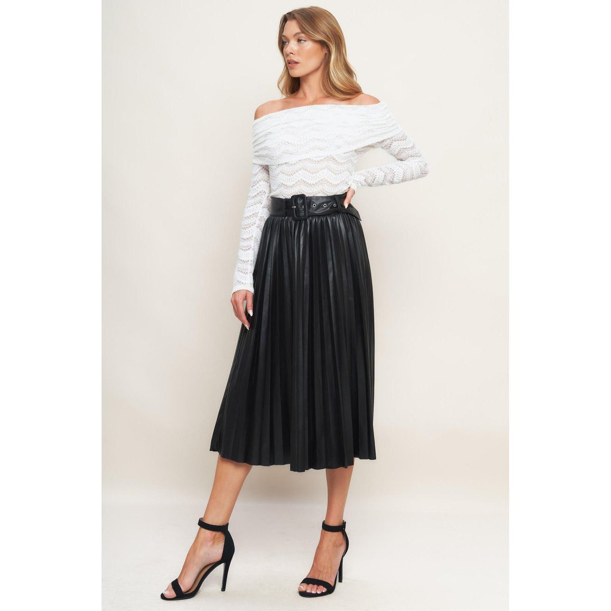 a woman in a white shirt and black skirt
