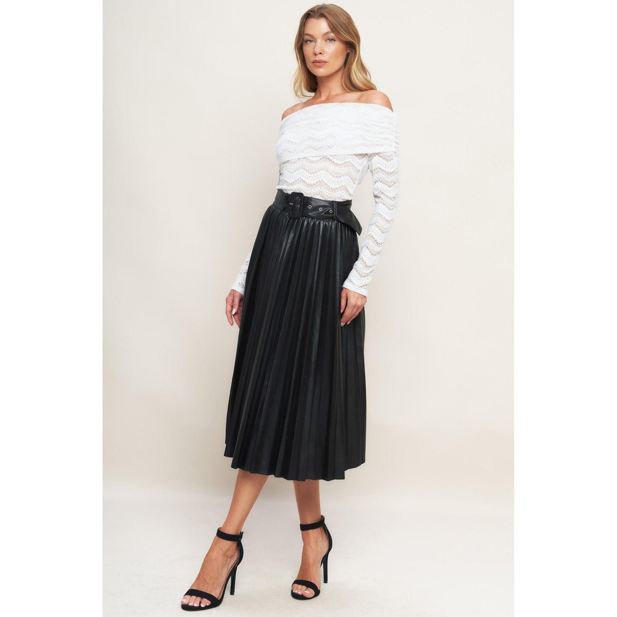 a woman in a white shirt and black skirt