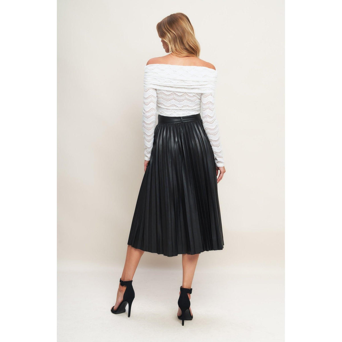 a woman in a white shirt and black skirt