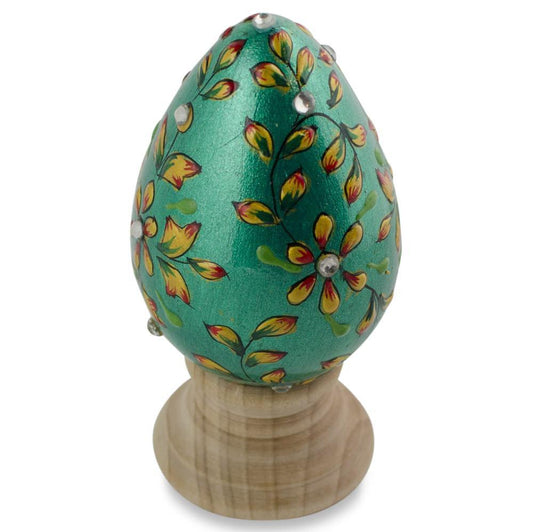 a green egg with yellow flowers on it