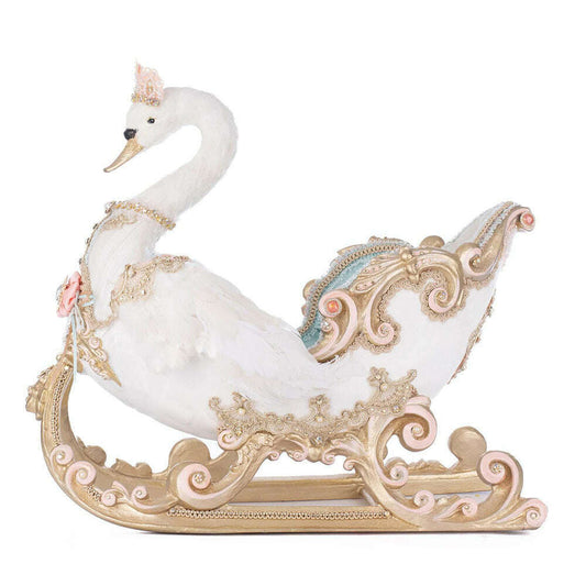 a white swan on a gold sleigh
