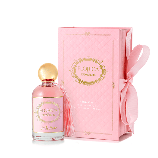a pink box with a bottle of perfume