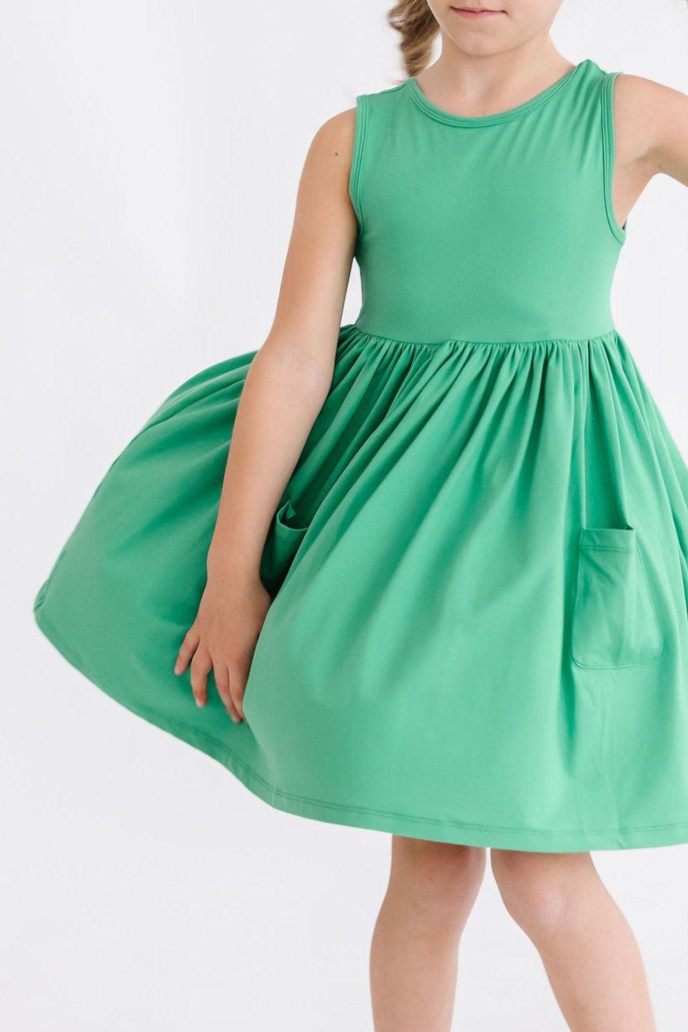 a girl wearing a green dress