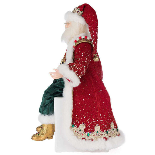 a statue of a santa claus sitting on a white surface