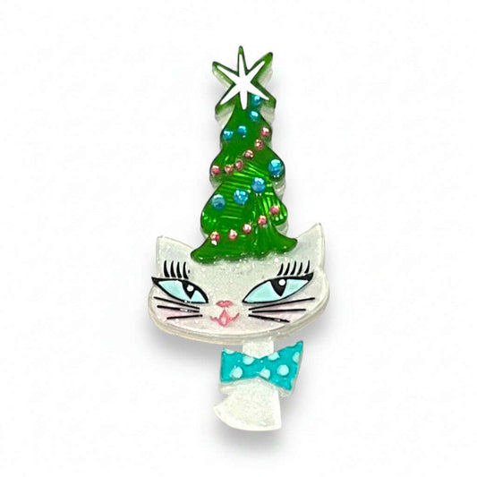 a cat shaped brooch with a christmas tree
