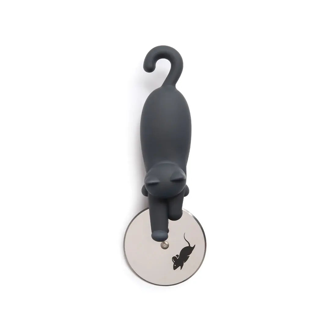 a grey cat figurine on a round metal object