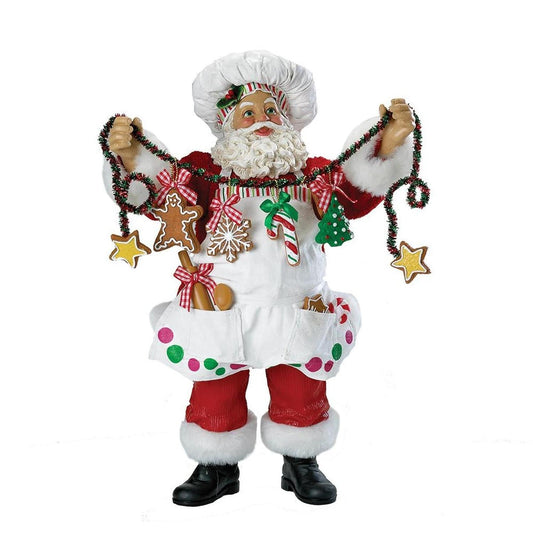 a santa claus holding a garland of cookies