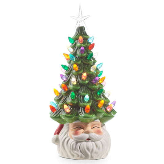 a ceramic santa claus with a christmas tree
