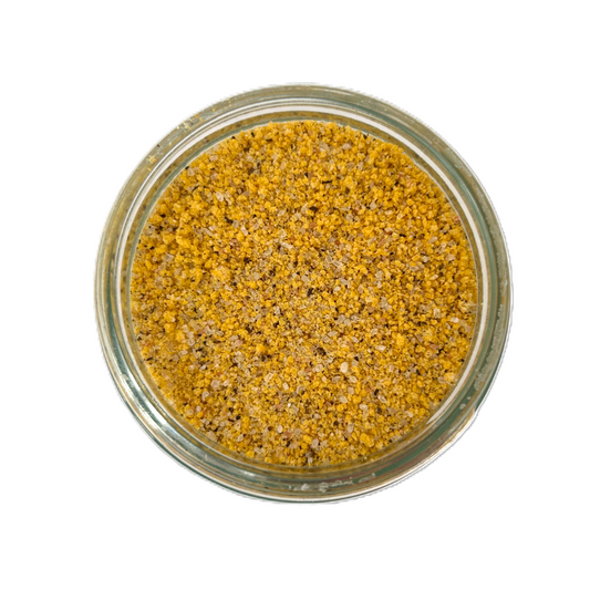 a glass jar with yellow and black grains