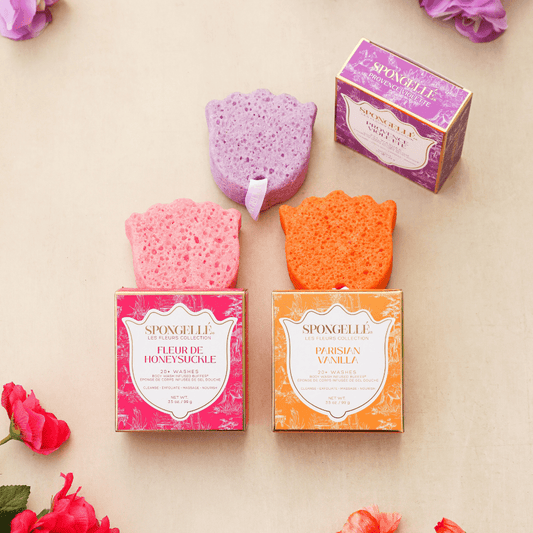 a group of sponges in boxes next to flowers