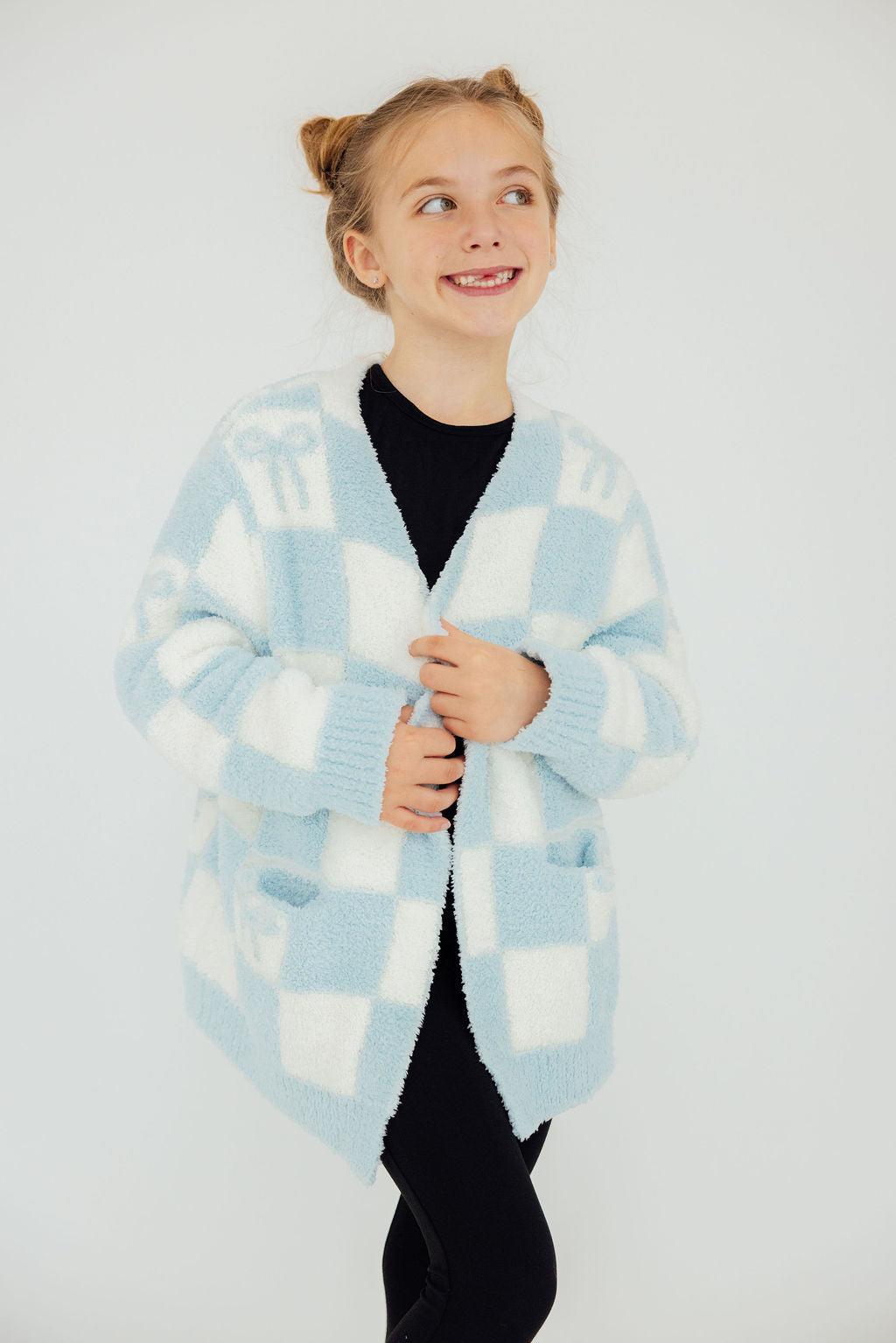 a girl smiling with her hands on her jacket