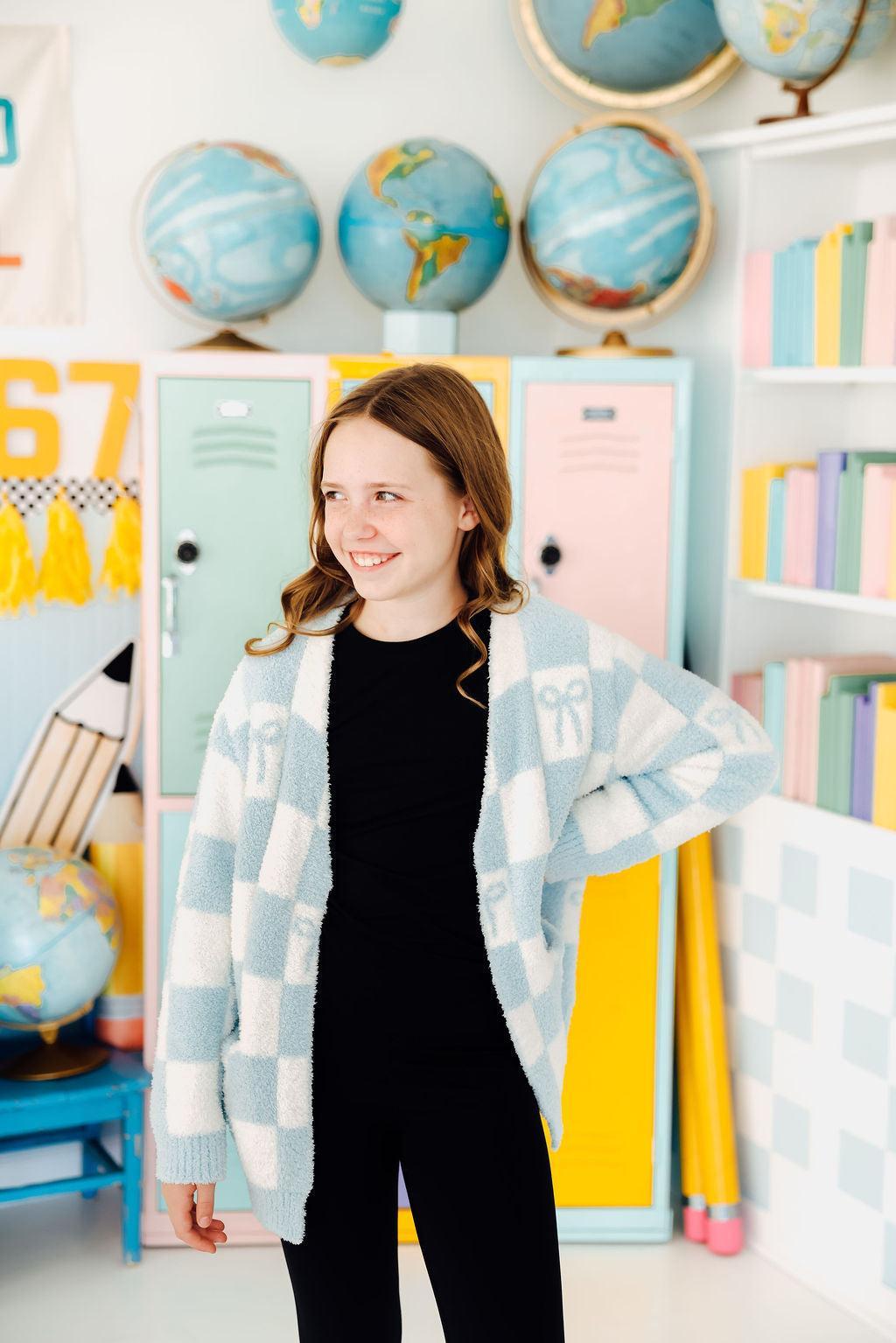 a girl in a room with school lockers and globes