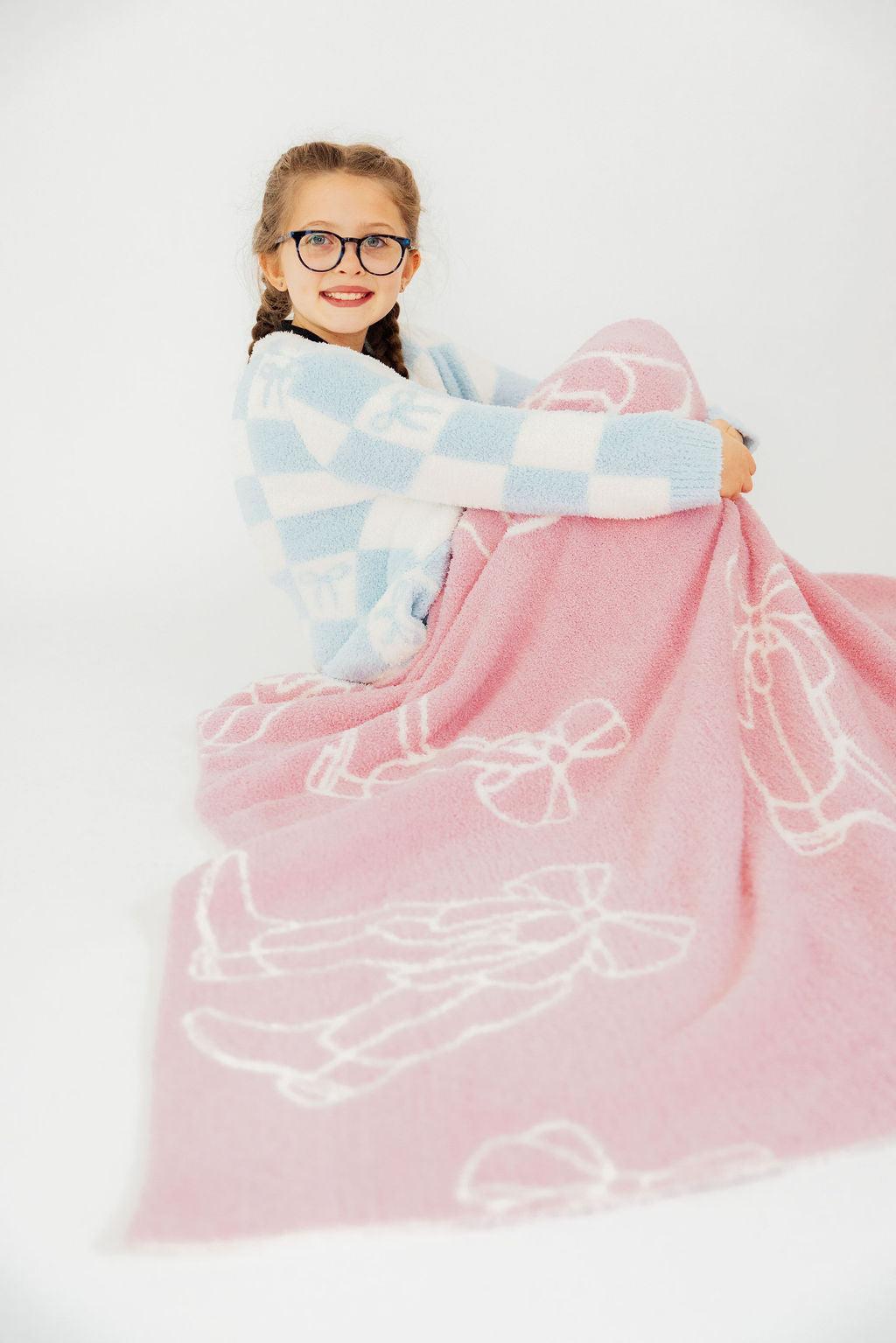 a girl wrapped in a blanket