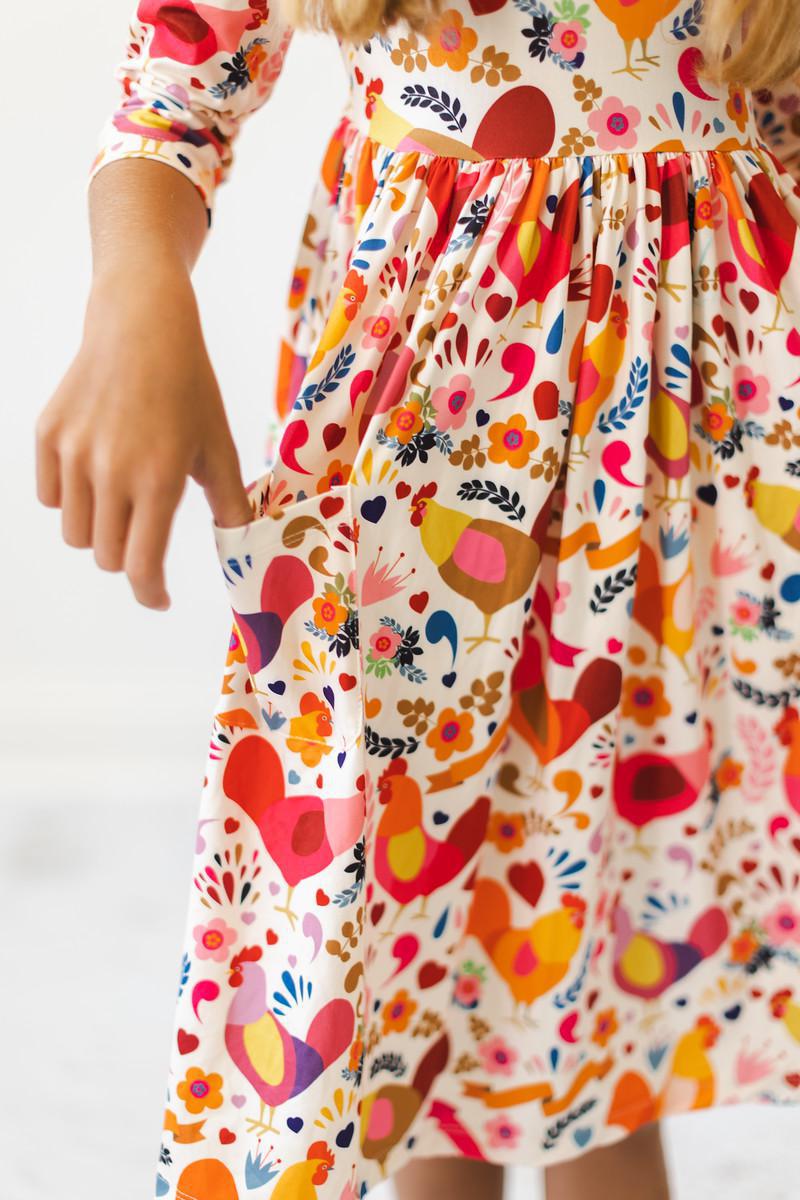 a woman wearing a dress with a floral print