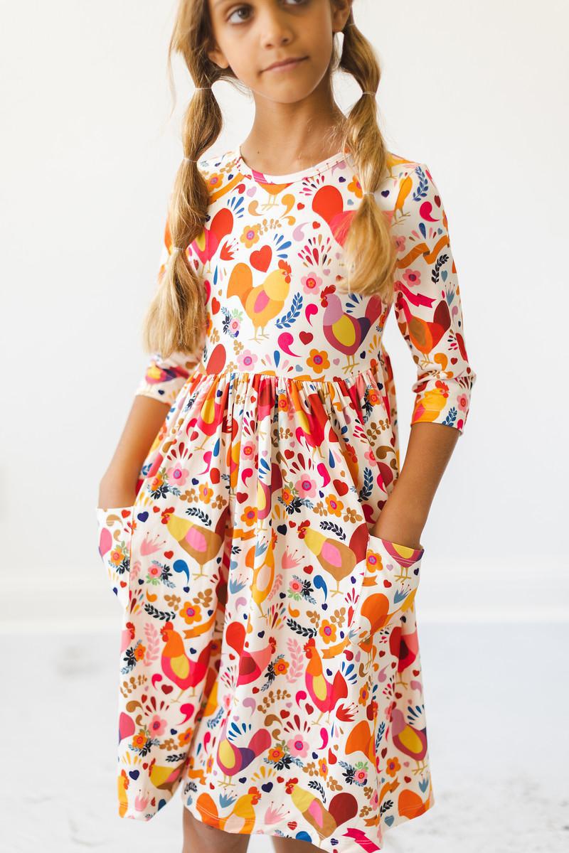 a girl with pigtails wearing a dress