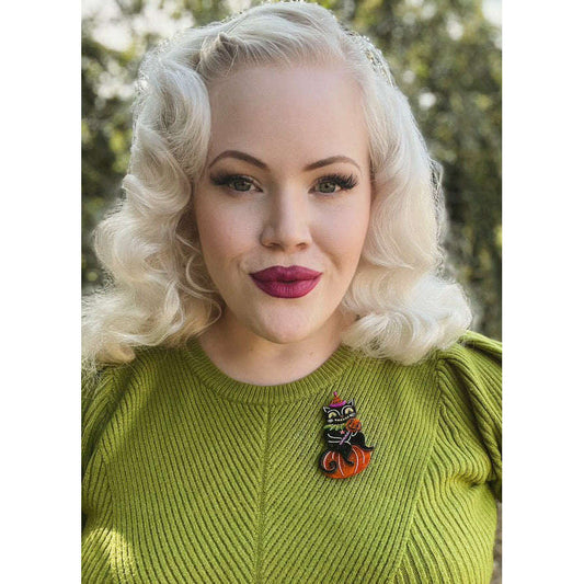 a woman with blonde hair wearing a green sweater