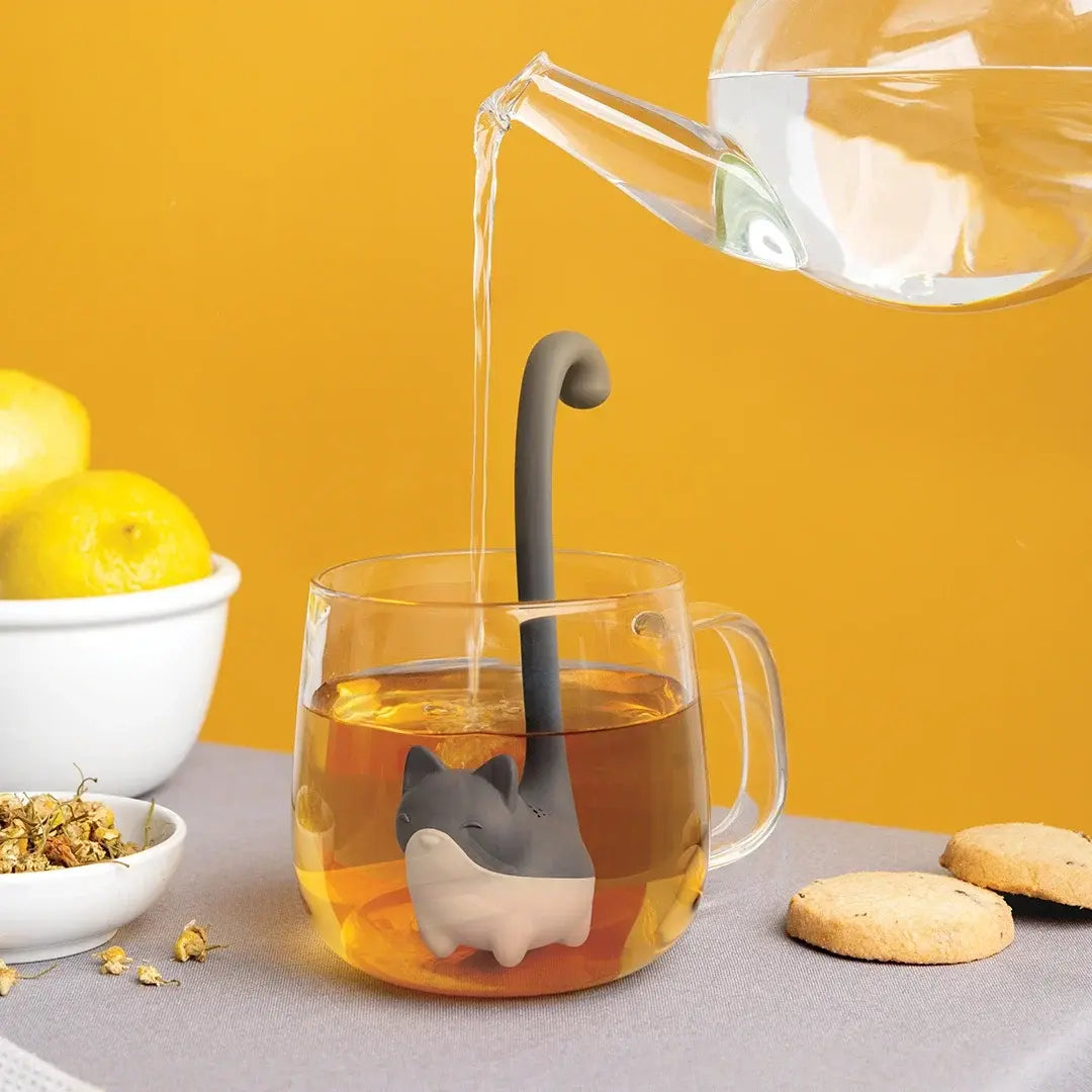 a glass cup with a cat shaped object in it