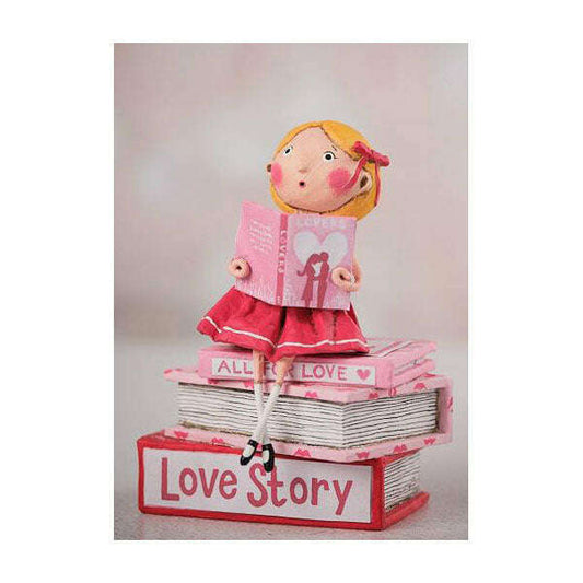a figurine of a girl sitting on a stack of books