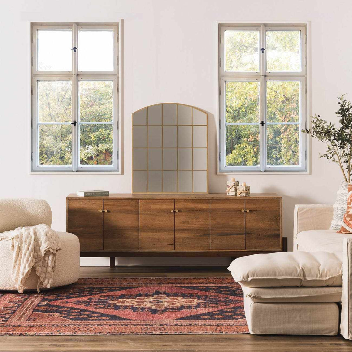 a room with a dresser and couches