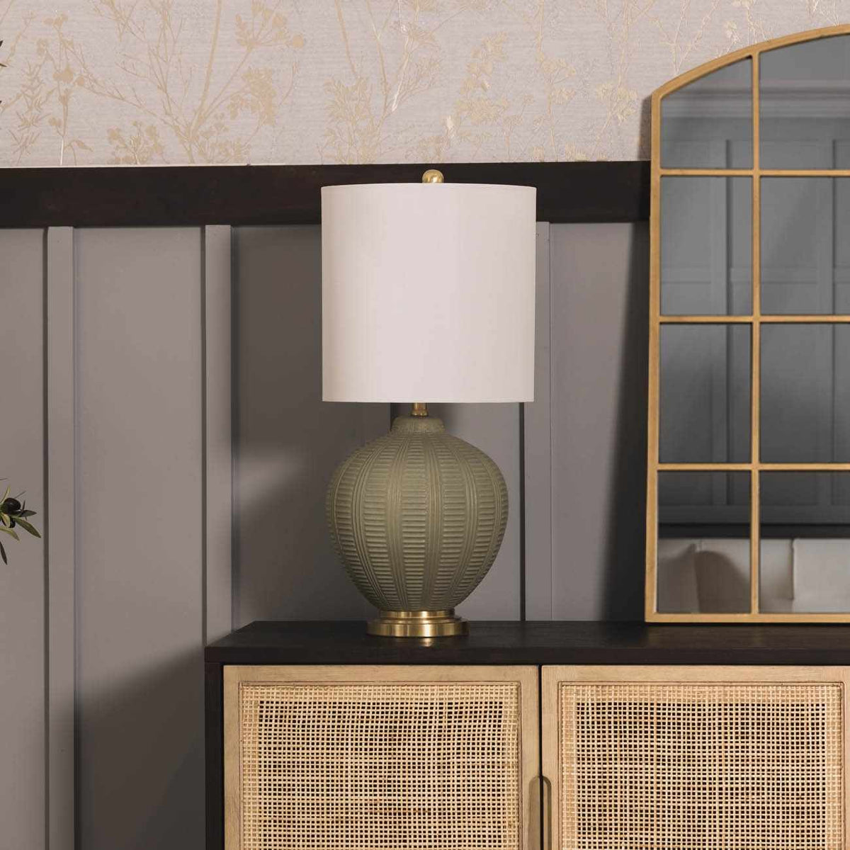 a lamp on a cabinet