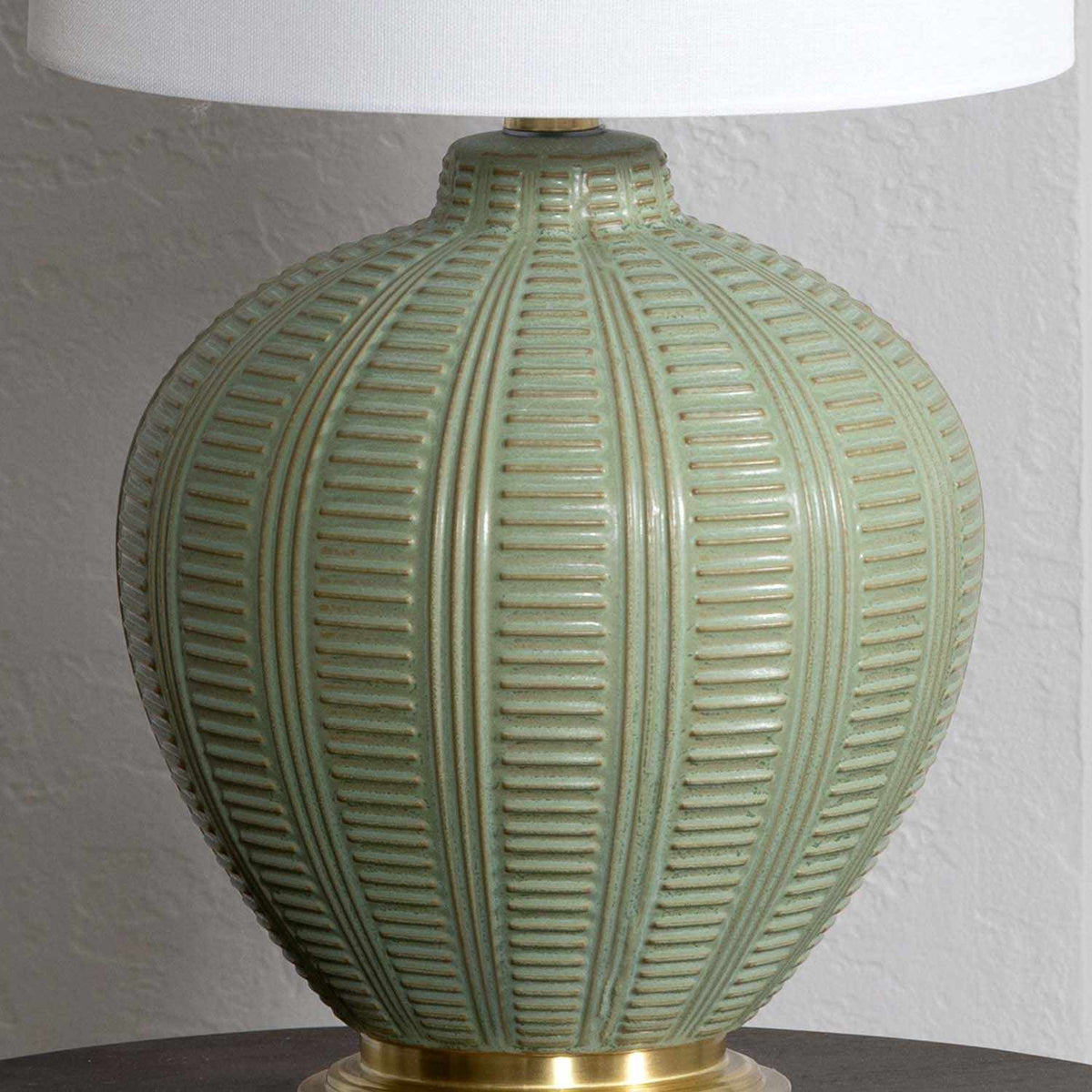 a green lamp with a white shade