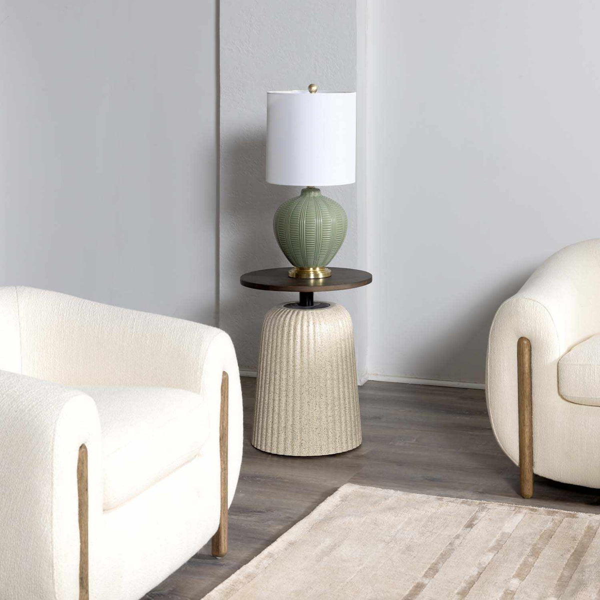 a lamp on a table next to a white chair