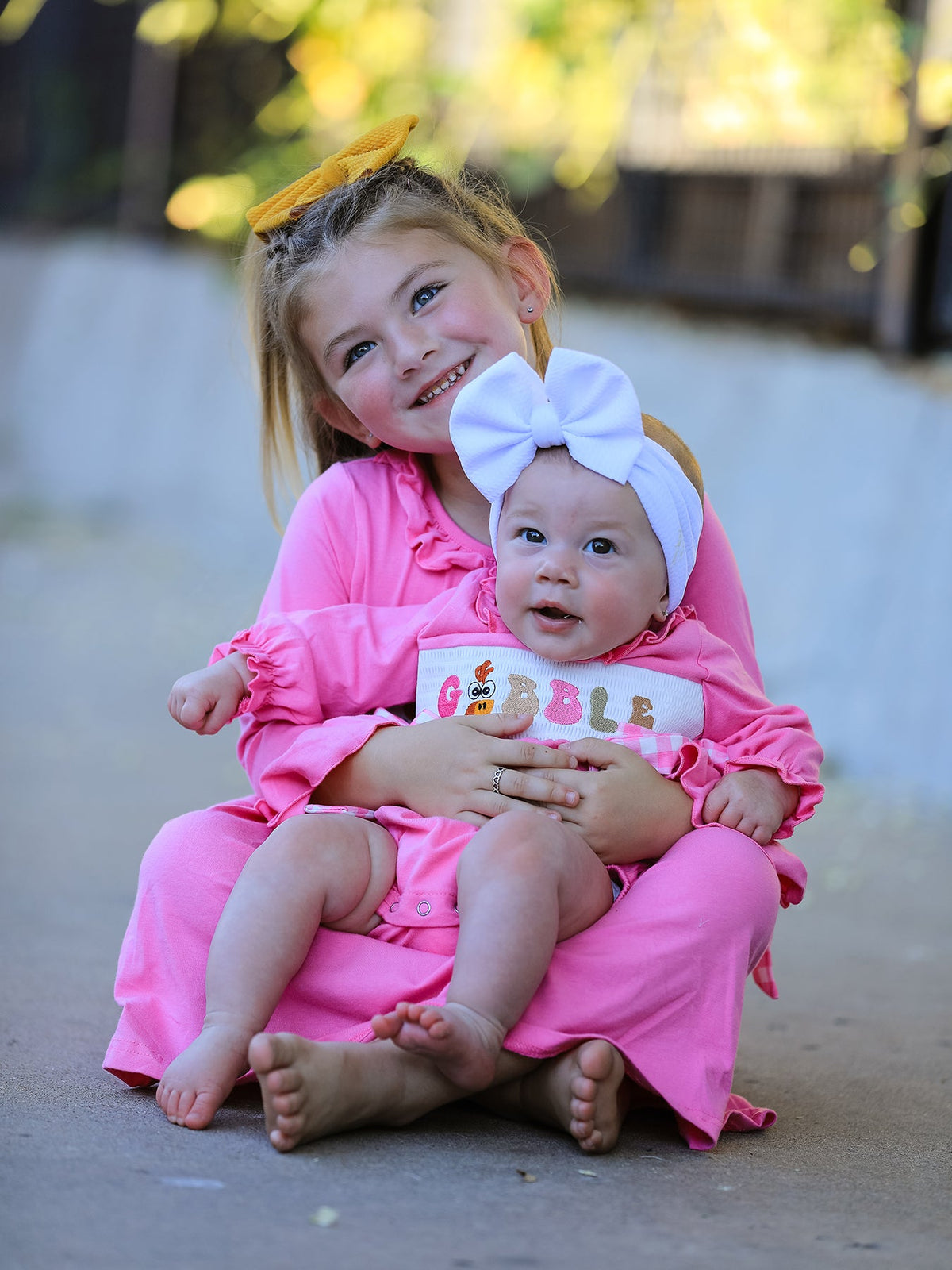 a girl holding a baby