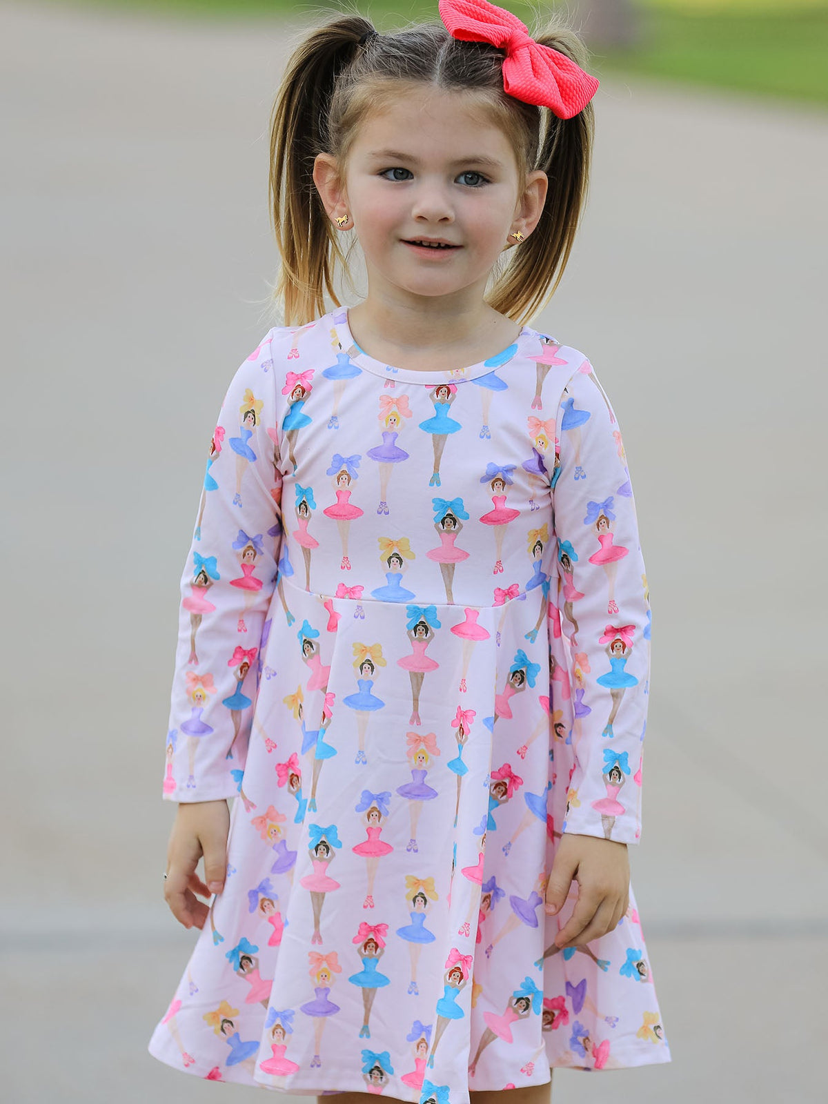 a girl with pig tails wearing a dress