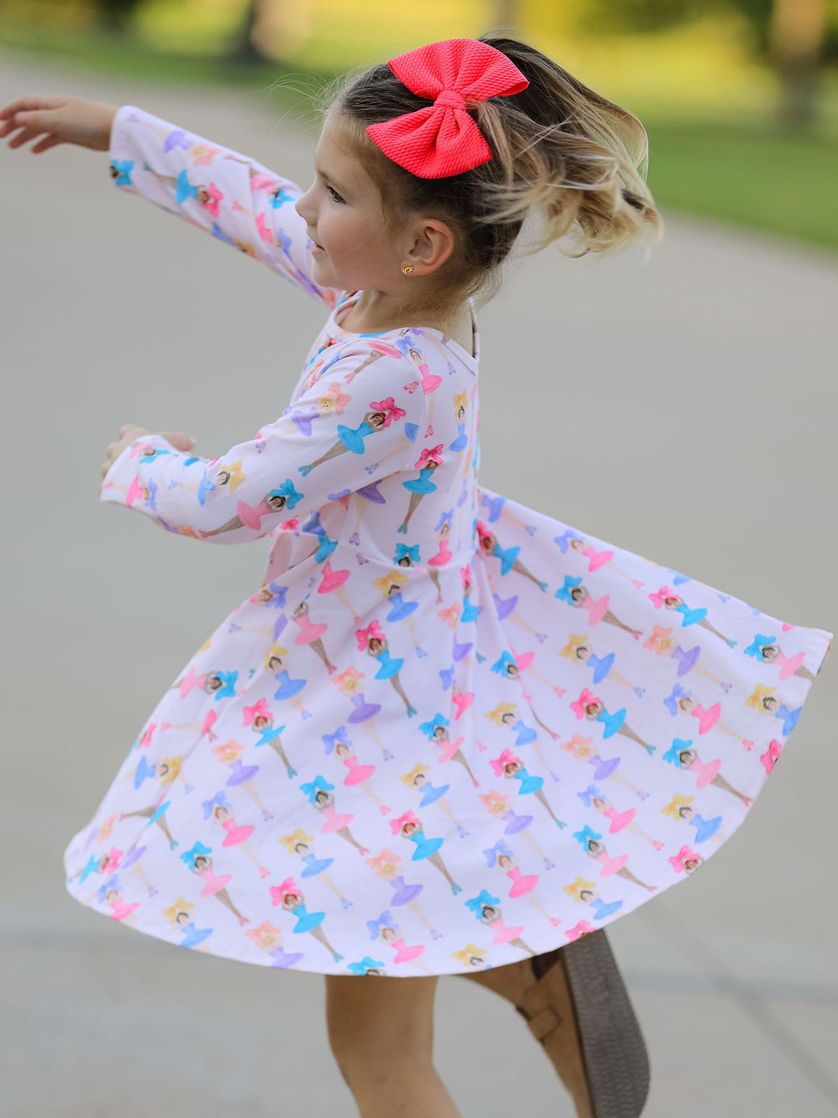 a girl in a dress with a red bow