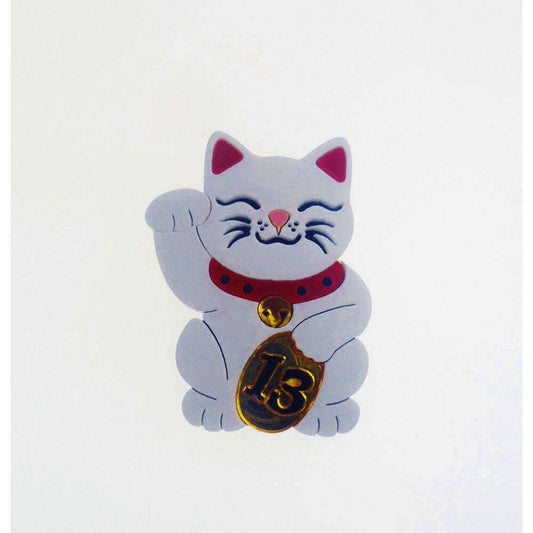 a white cat with a gold coin