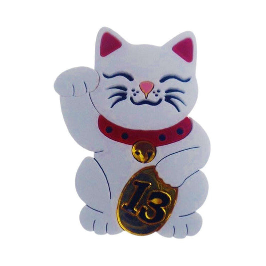 a white cat with a gold coin