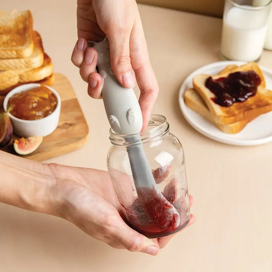 a person holding a jar with jam