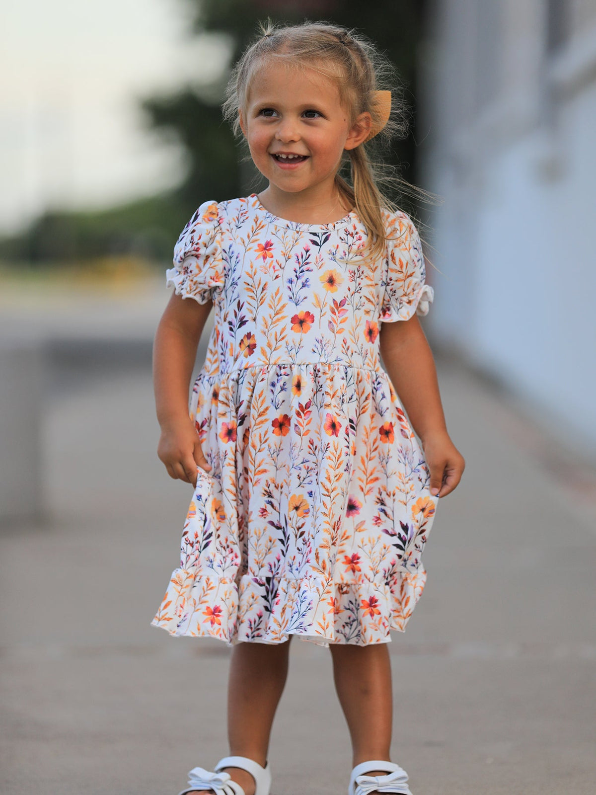 a girl in a dress and hat