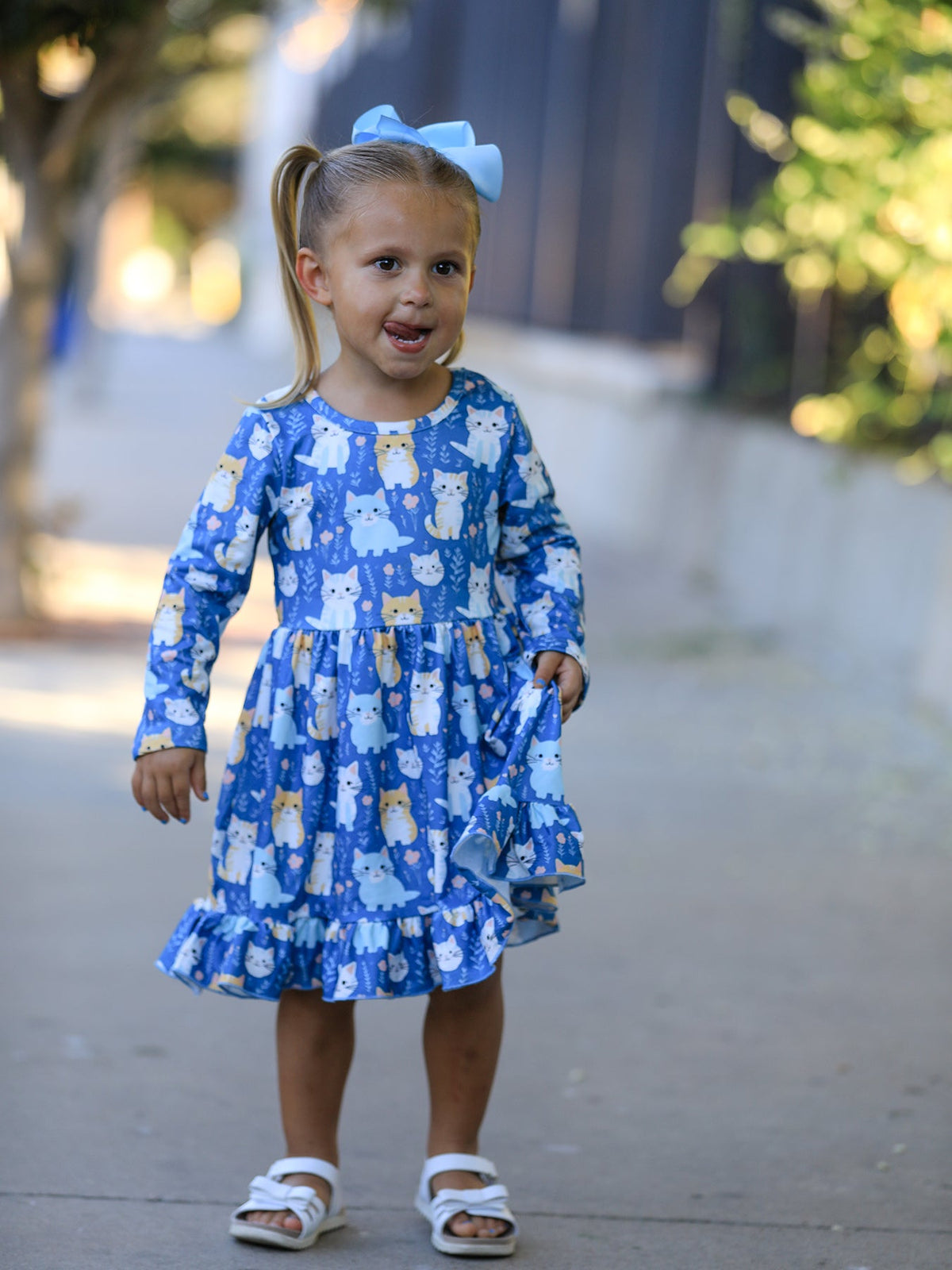 a girl wearing a blue dress with a blue bow