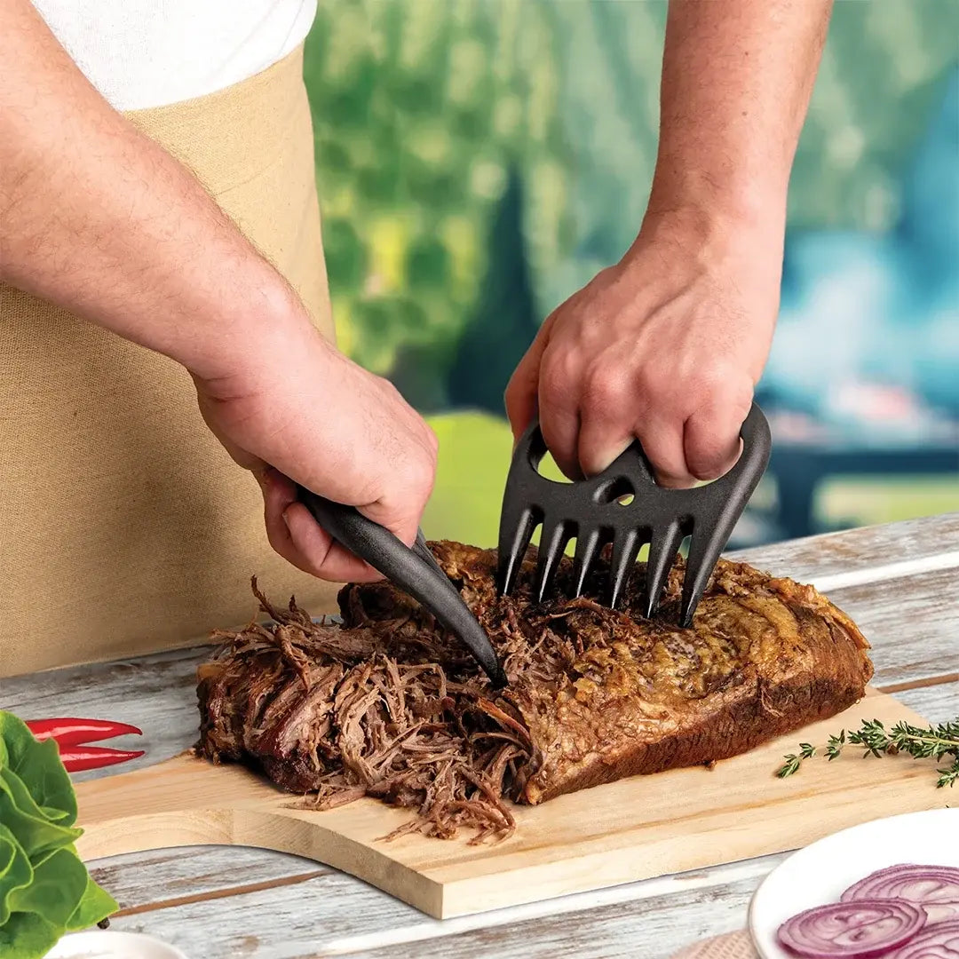 a person cutting meat with tongs