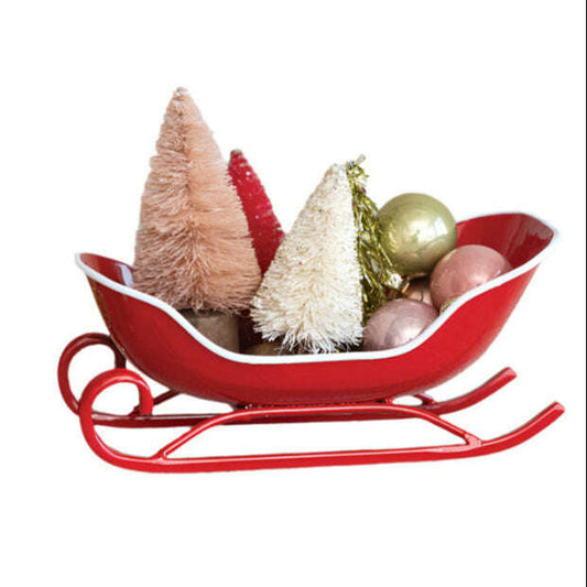 a red sleigh with christmas trees and ornaments