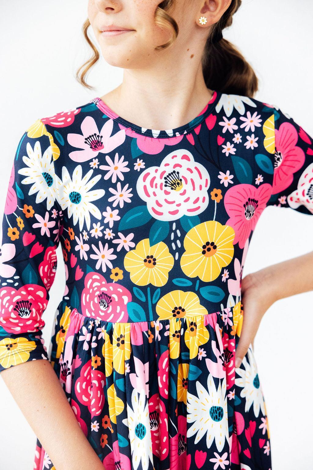 a girl wearing a colorful dress