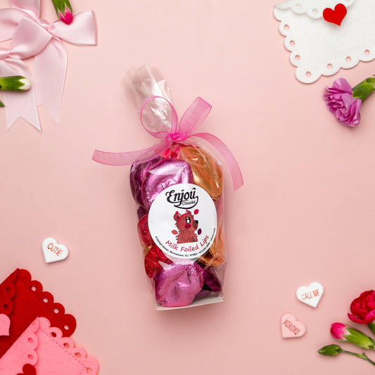 a bag of candy next to flowers