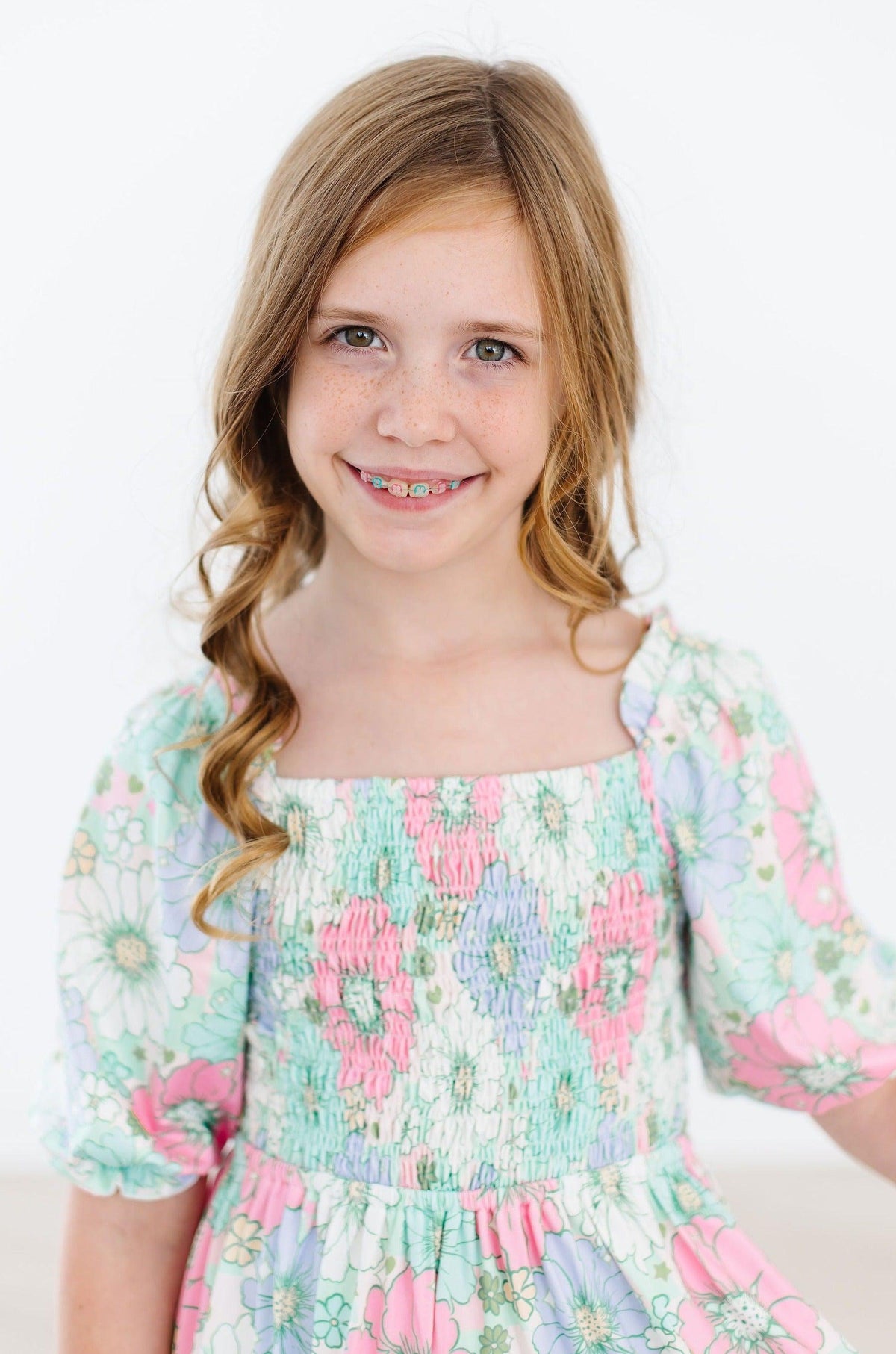 a girl with braces smiling