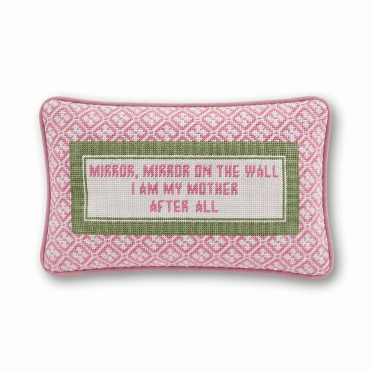 a pink and green pillow with a white rectangular object with a white border