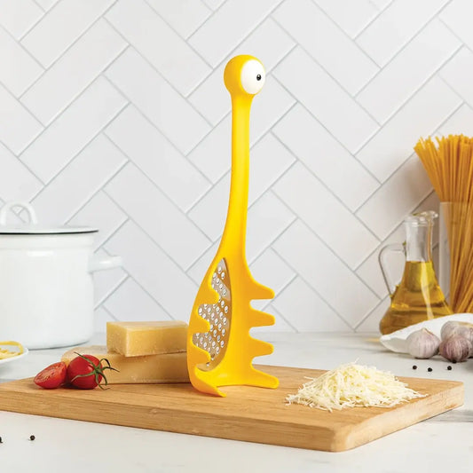 a yellow spaghetti grater on a cutting board
