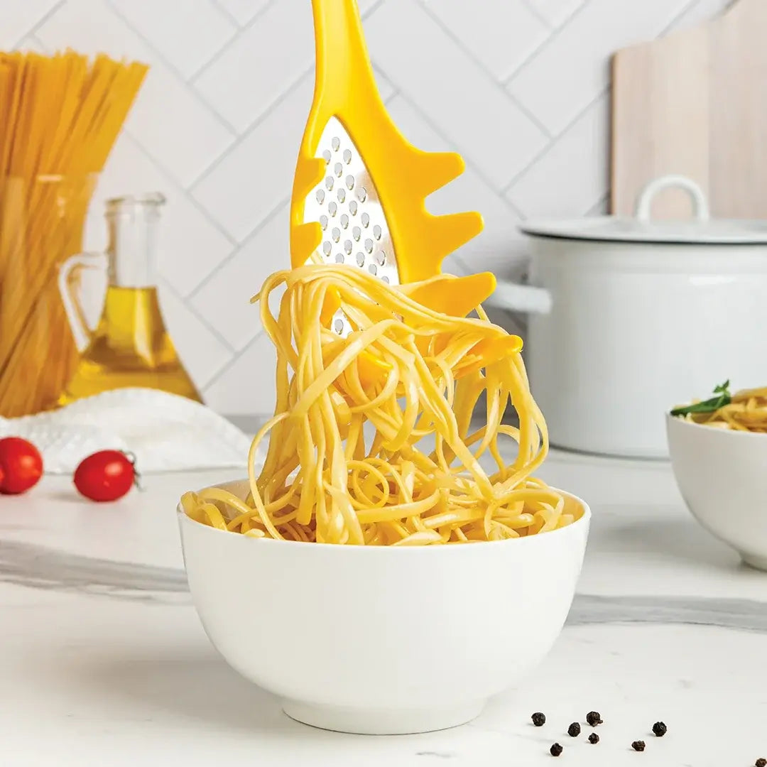a bowl of noodles with a grater